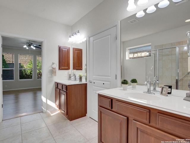 bathroom featuring ceiling fan, hardwood / wood-style flooring, walk in shower, and vanity