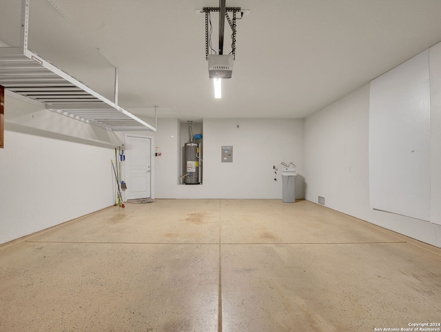 garage featuring electric panel, gas water heater, and a garage door opener