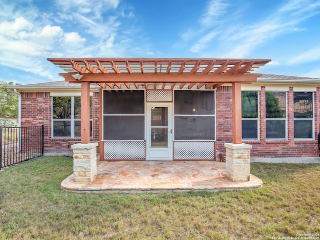 back of house with a pergola, a yard, and a patio