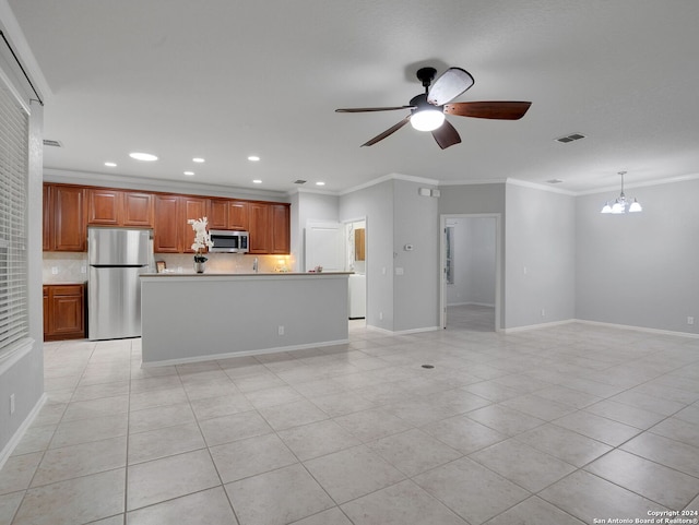 kitchen with light tile patterned floors, ceiling fan with notable chandelier, stainless steel appliances, pendant lighting, and a kitchen island