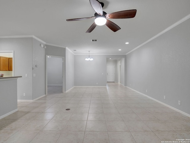 empty room featuring ceiling fan with notable chandelier, light tile patterned floors, and ornamental molding