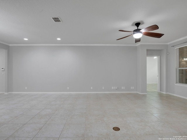 tiled empty room with ornamental molding and ceiling fan