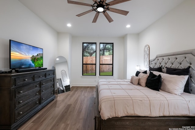 bedroom with baseboards, a ceiling fan, wood finished floors, and recessed lighting