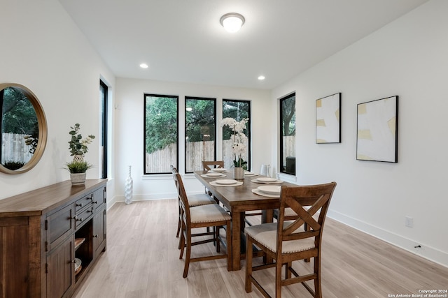 dining room featuring recessed lighting, baseboards, and light wood-style flooring