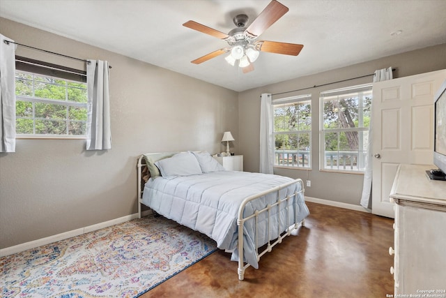 bedroom with multiple windows and ceiling fan