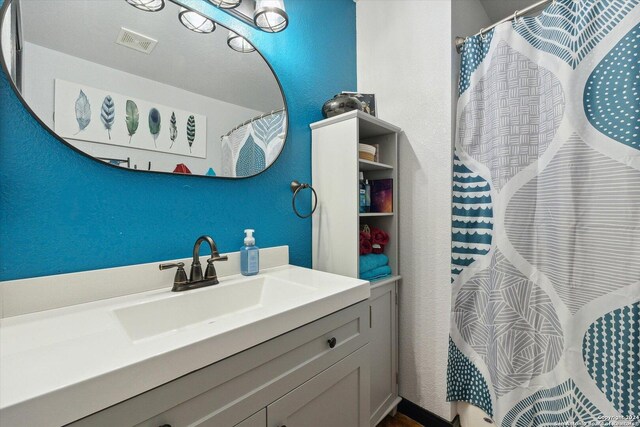 bathroom with vanity and a shower with shower curtain