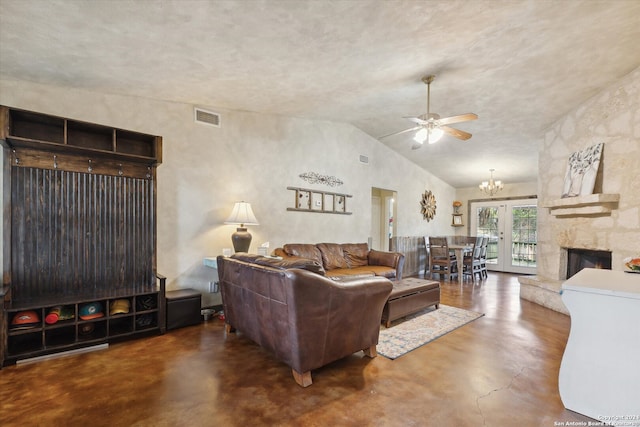 living room with lofted ceiling, ceiling fan with notable chandelier, and a fireplace