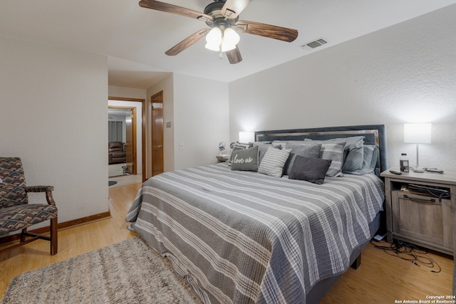 bedroom with light wood-type flooring and ceiling fan