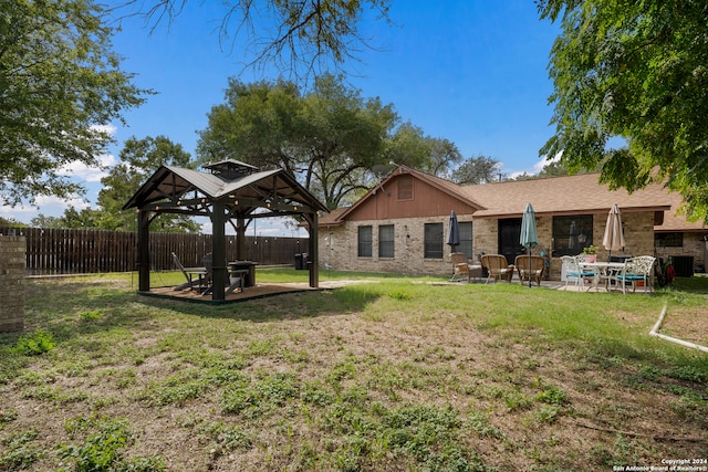 back of property with a patio, a gazebo, and a yard