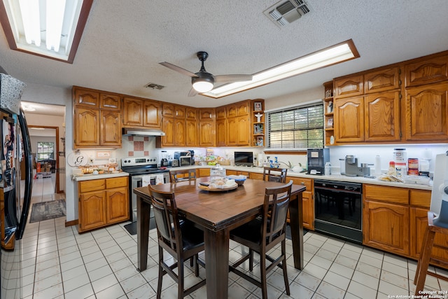 kitchen featuring black appliances, ceiling fan, light tile patterned floors, and a textured ceiling