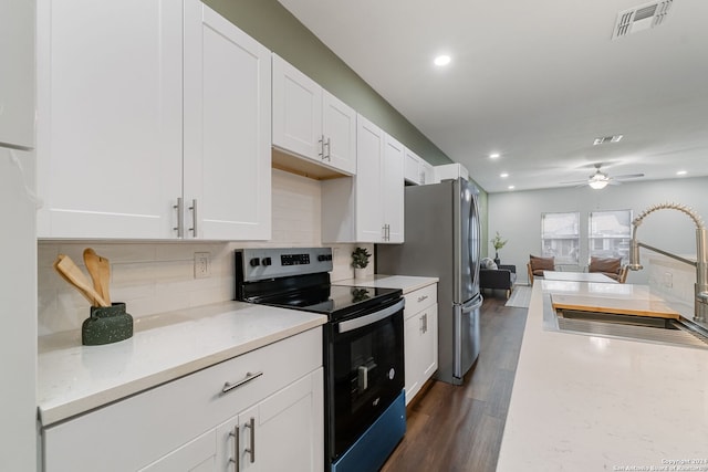 kitchen featuring white cabinets, sink, range with electric stovetop, dark wood-type flooring, and ceiling fan