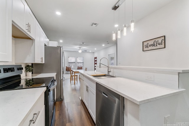 kitchen featuring stainless steel appliances, sink, dark hardwood / wood-style floors, and white cabinets