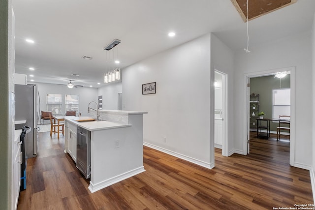 kitchen with sink, ceiling fan, dark wood-type flooring, a center island with sink, and white cabinets