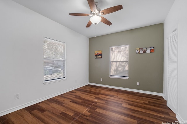 spare room with ceiling fan and dark hardwood / wood-style flooring