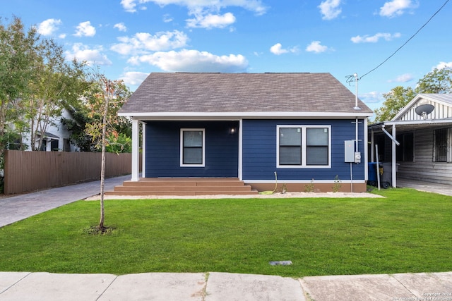 bungalow-style home with a front yard