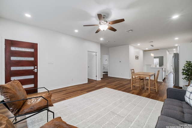 living room with ceiling fan and dark hardwood / wood-style floors