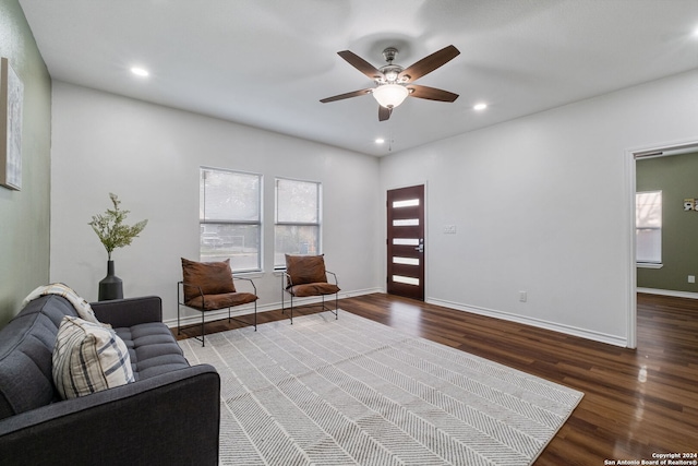 living room featuring ceiling fan and hardwood / wood-style floors