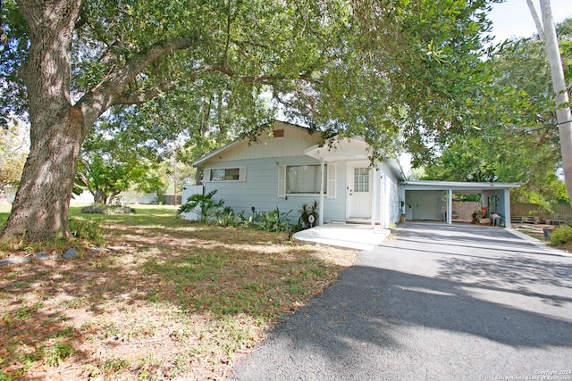 ranch-style house featuring a carport