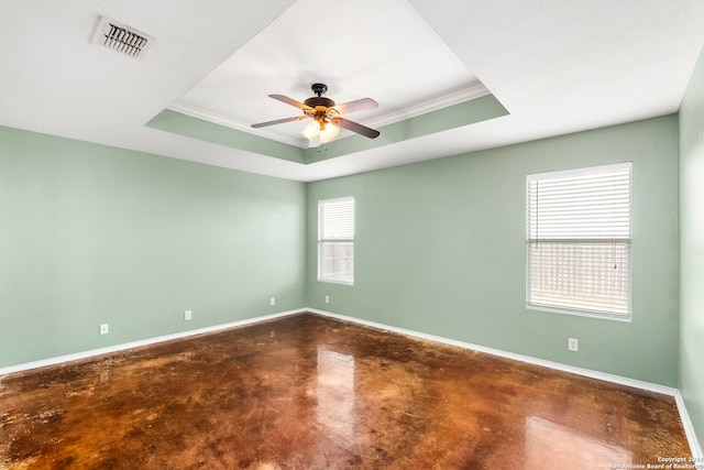 unfurnished room with visible vents, a raised ceiling, and baseboards