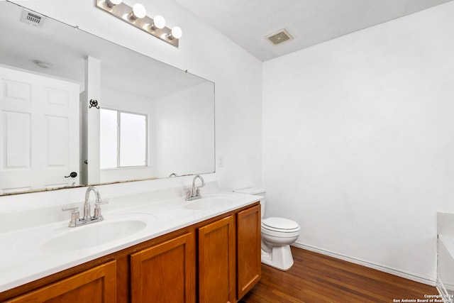 bathroom with visible vents, toilet, and a sink