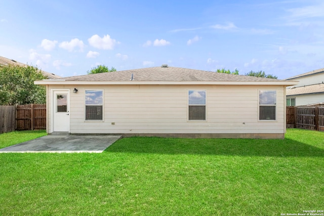 back of house featuring a yard, a fenced backyard, and a patio area