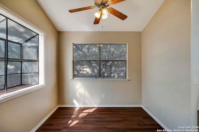 empty room featuring dark hardwood / wood-style flooring, ceiling fan, and lofted ceiling