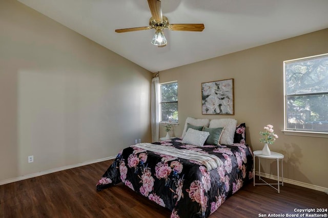 bedroom featuring vaulted ceiling, dark hardwood / wood-style flooring, and ceiling fan