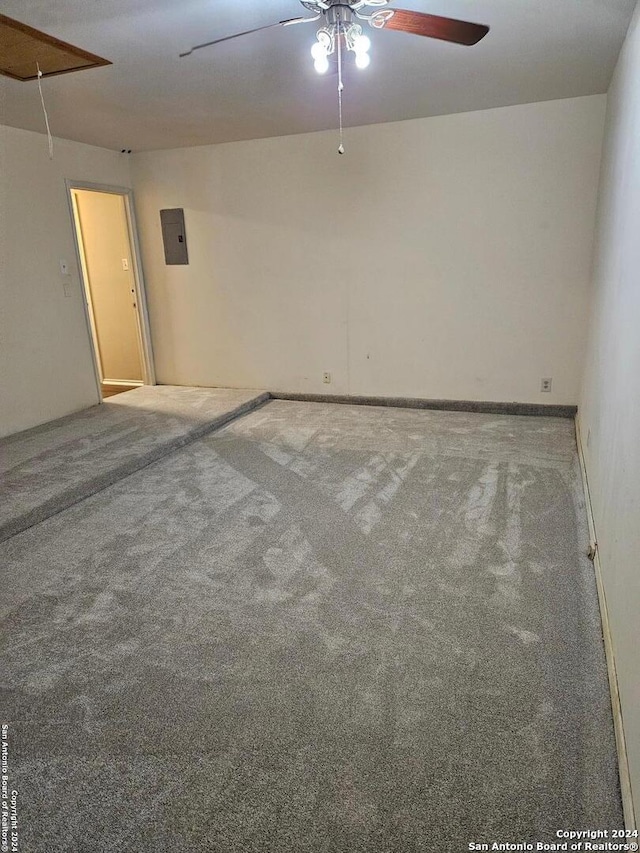 unfurnished room featuring carpet flooring, ceiling fan, and electric panel