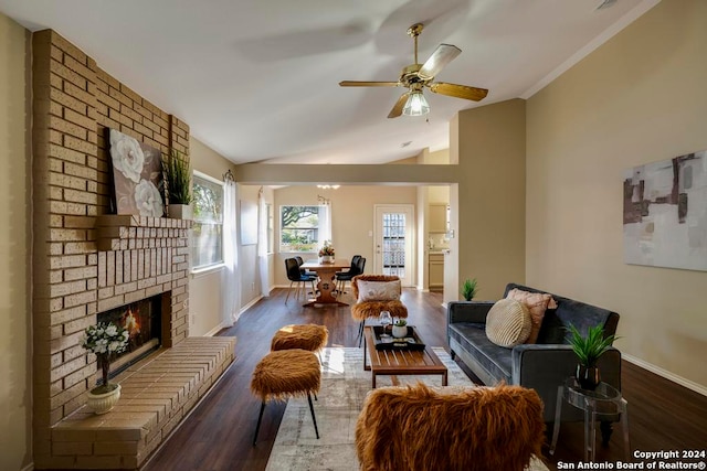 living room with dark hardwood / wood-style flooring, a brick fireplace, ceiling fan, and lofted ceiling