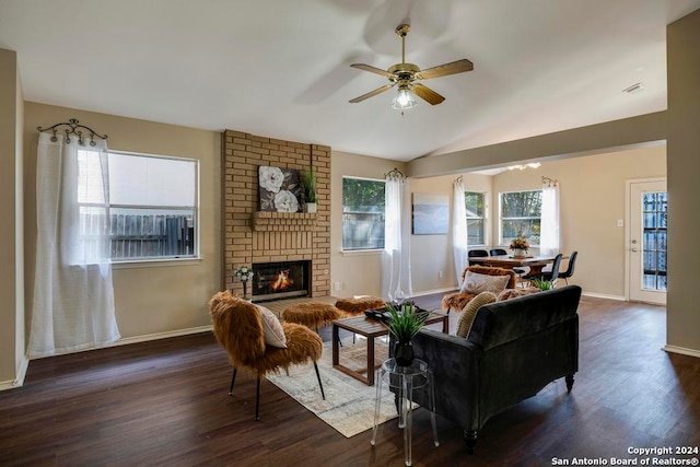 living room featuring a brick fireplace, ceiling fan, and dark hardwood / wood-style floors