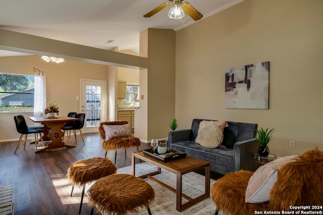 living room with lofted ceiling, ceiling fan with notable chandelier, and dark hardwood / wood-style flooring