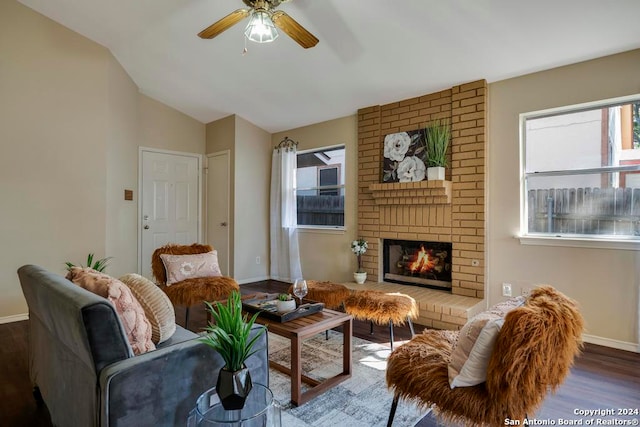 living room with lofted ceiling, ceiling fan, a fireplace, and dark hardwood / wood-style floors