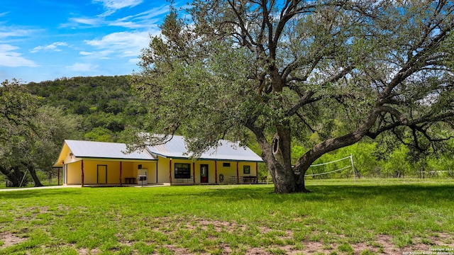 201 N Tomahawk Way, Concan, TX 78801 - back of house featuring a yard, a carport, and a forest view