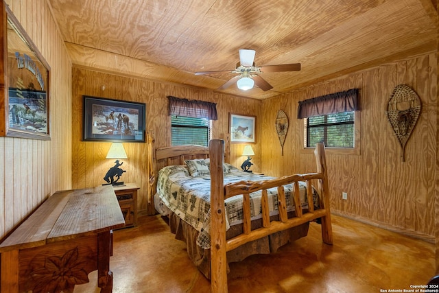 bedroom with concrete flooring, wooden walls, ceiling fan, and wooden ceiling