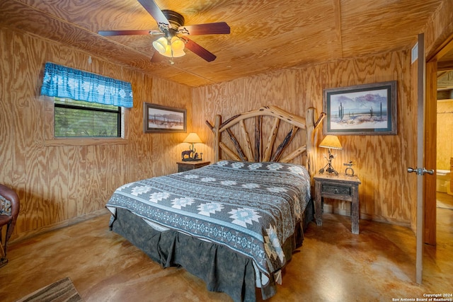 bedroom featuring concrete floors, ceiling fan, wooden ceiling, and wood walls