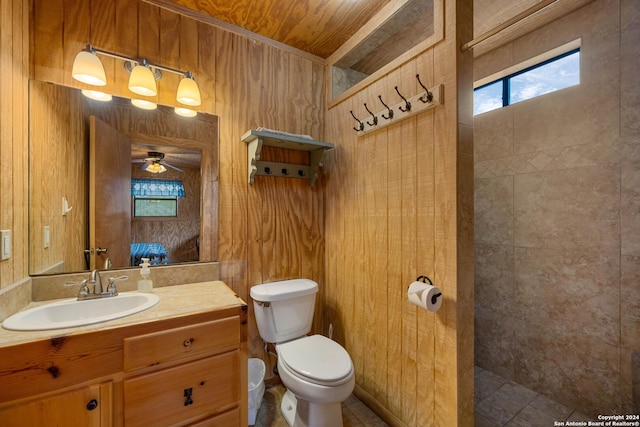 bathroom with ceiling fan, a wealth of natural light, and wood walls