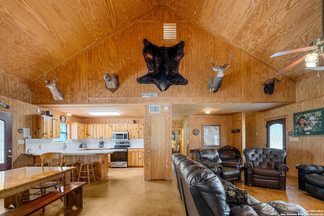 living room featuring wooden walls, high vaulted ceiling, and wooden ceiling