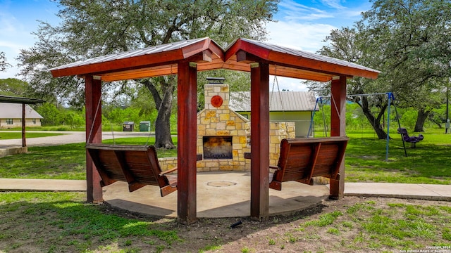 view of patio with an outdoor stone fireplace