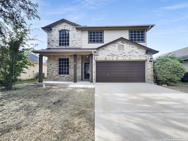 view of front of house with a garage, concrete driveway, a porch, and brick siding