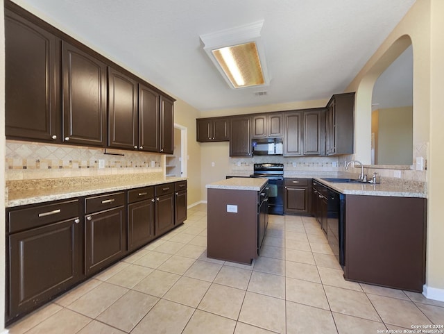 kitchen with black appliances, a sink, tasteful backsplash, light tile patterned flooring, and dark brown cabinets