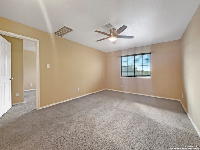 empty room featuring ceiling fan and carpet floors