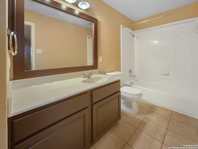 bathroom featuring tile patterned flooring, tub / shower combination, toilet, and vanity