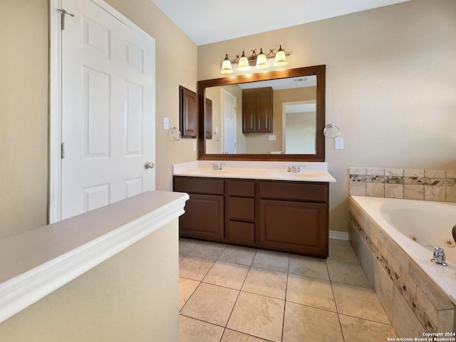 full bathroom with a sink, a tub with jets, tile patterned floors, and double vanity