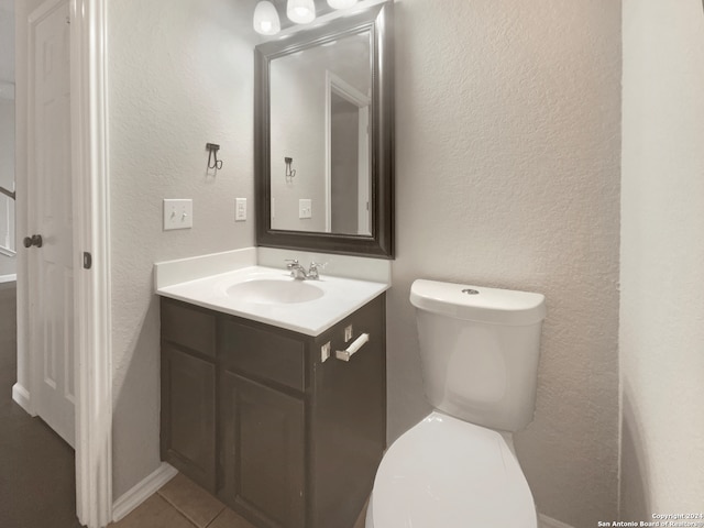 bathroom with tile patterned floors, toilet, and vanity