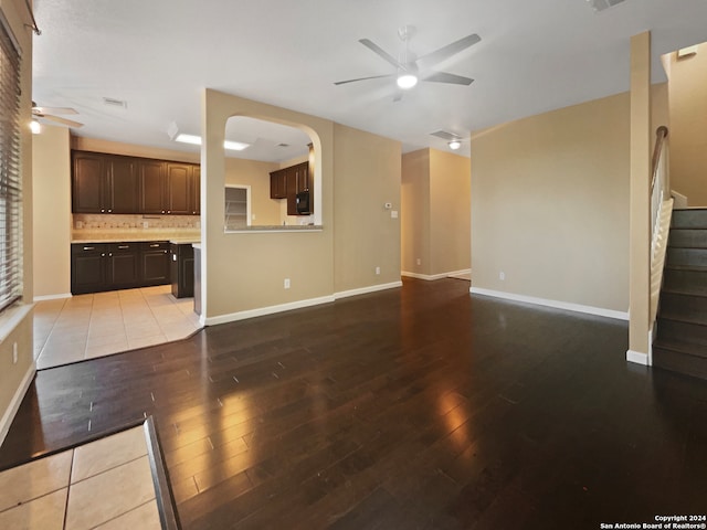 unfurnished living room with ceiling fan and light hardwood / wood-style flooring