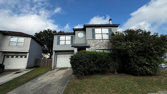 view of front of property with a garage and a front lawn