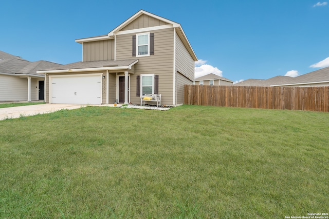 view of property with a garage and a front lawn