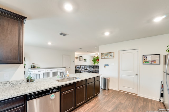 kitchen with light hardwood / wood-style flooring, dishwasher, light stone counters, sink, and dark brown cabinetry