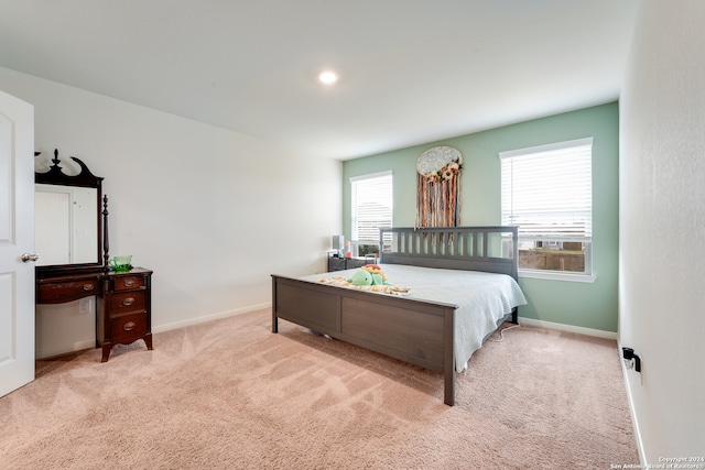 carpeted bedroom with multiple windows