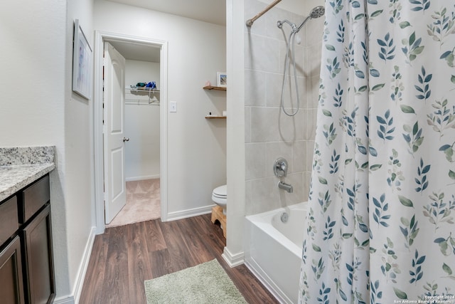 full bathroom featuring toilet, hardwood / wood-style flooring, shower / tub combo, and vanity